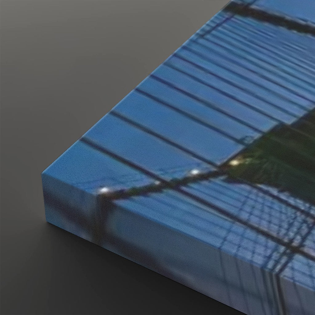 A rectangular canvas or print showing an abstract blue-toned architectural or grid-like scene, photographed at an angle on a dark gray background.