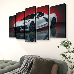 A five-panel canvas wall art set depicting a white sports car against a red and black background, displayed above a green sofa in a living room setting.
