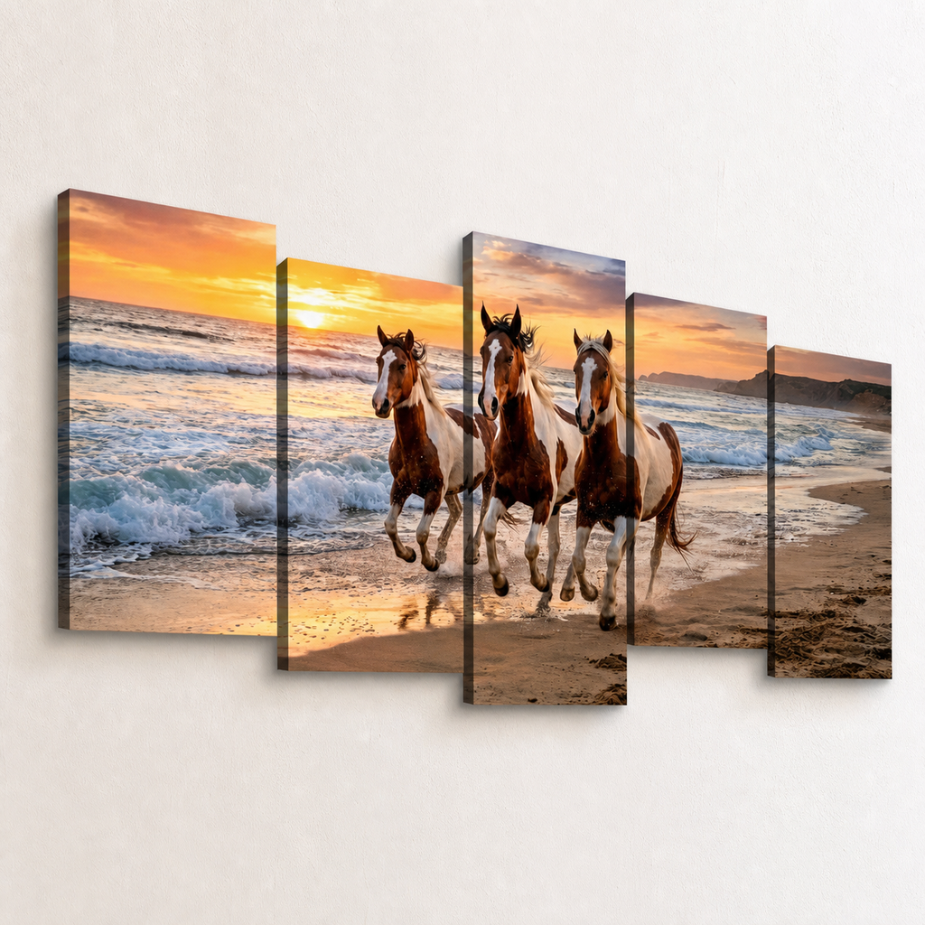 A five-panel canvas wall art set depicting three horses running along a sandy beach at sunset, mounted on a light beige wall.
