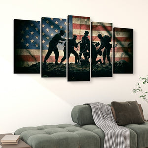 A five-panel canvas wall art set depicting silhouetted soldiers raising a fallen comrade against a distressed American flag, displayed above a green sofa in a living room setting.