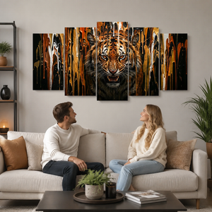 A 5-panel canvas wall art set depicting a roaring tiger with dramatic gold, orange, black, and brown abstract paint drips, displayed above a beige sofa in a modern living room setting with a couple sitting on the couch.