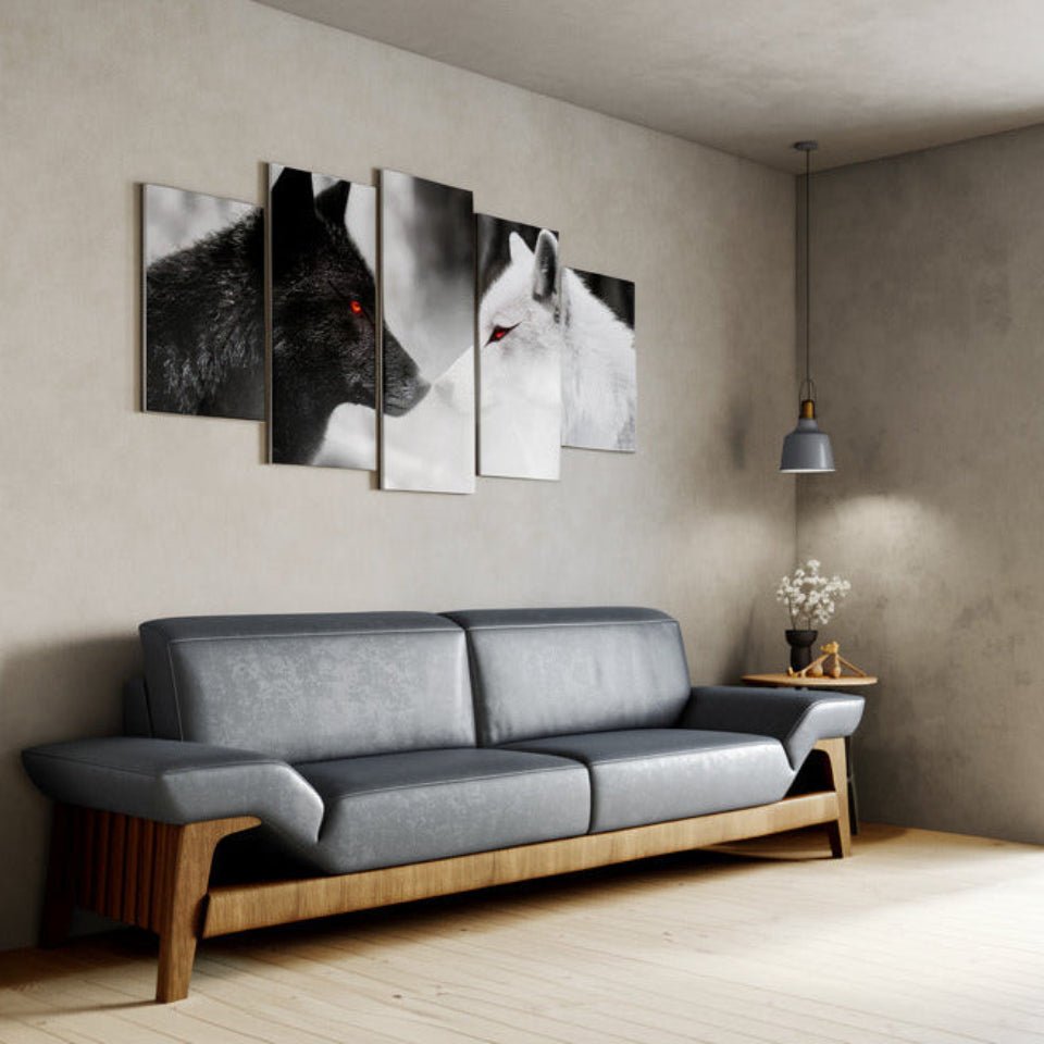 Gray sofa in a living room with wall art of wolves.