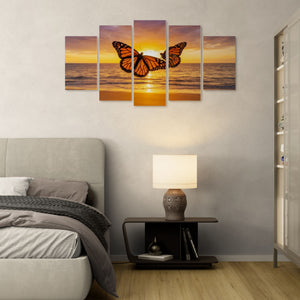 Bedroom with a sunset and butterfly wall art above a bed