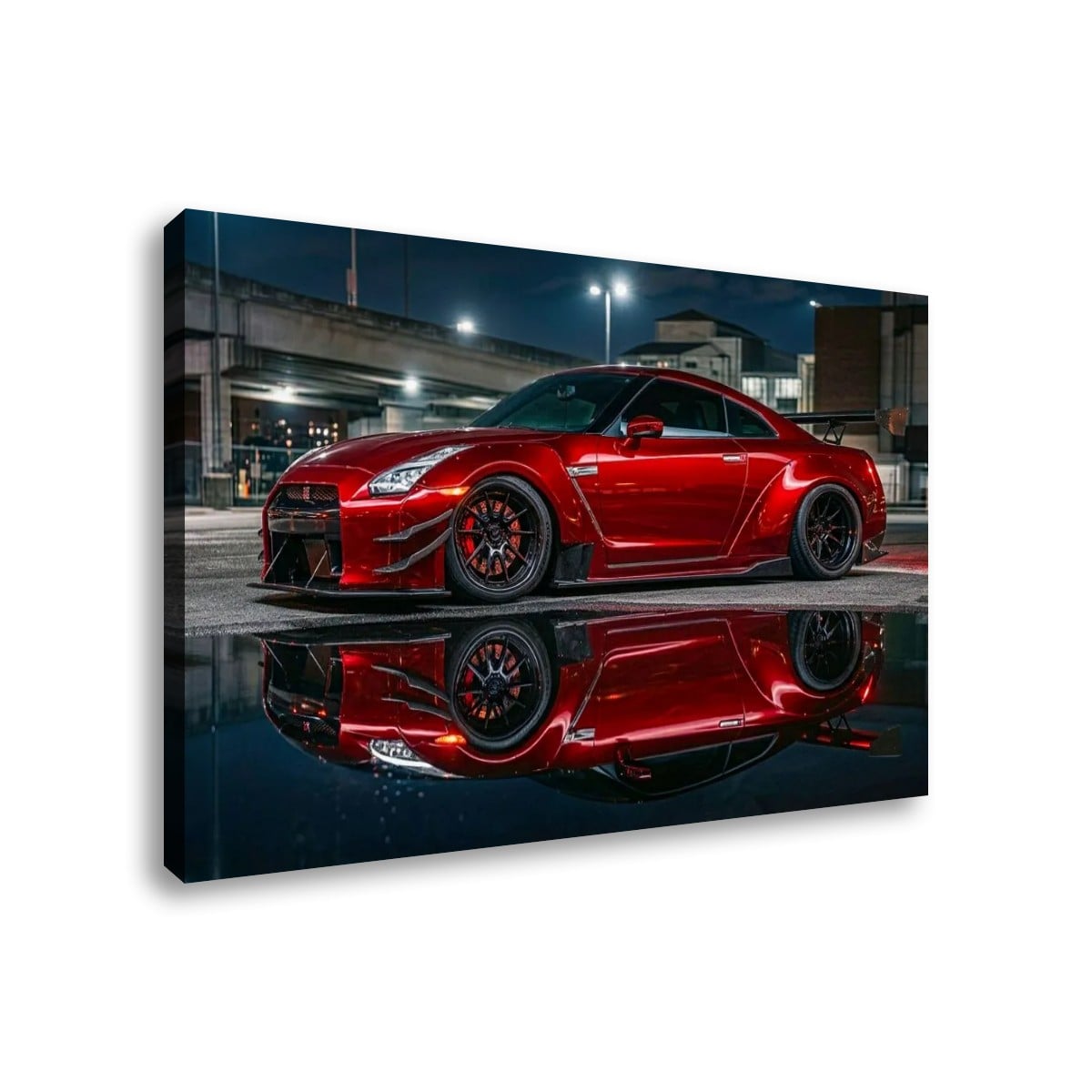 A rectangular wall art print or canvas showing a red sports car parked at night with its reflection on wet pavement, photographed against a plain white background.