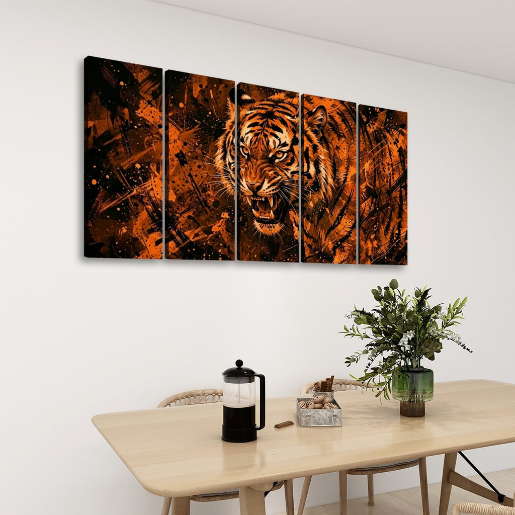 A five-panel canvas wall art set depicting a roaring tiger in vivid orange, brown, and black tones, displayed on a white wall above a light wood dining table with chairs, a French press, and a green plant.