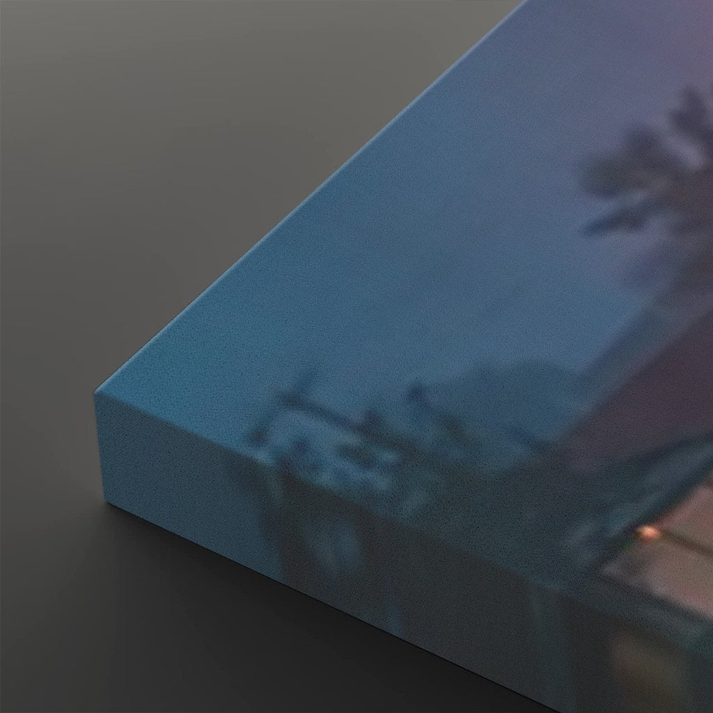 A close-up of a rectangular blue box or package corner on a dark gray background, with a softly blurred scenic print visible on its surface.