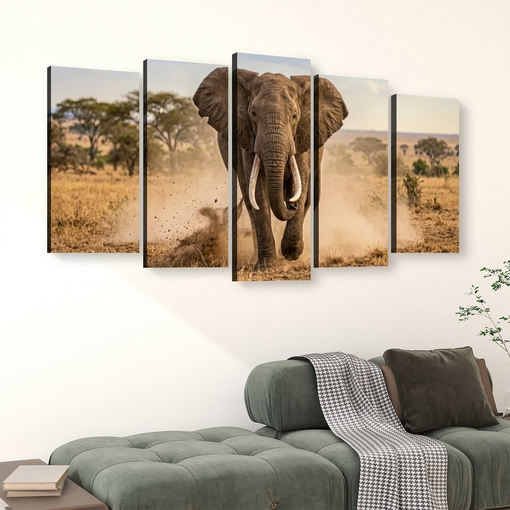 A five-panel canvas wall art set depicting a large elephant walking through a dry savanna landscape, displayed above a green sofa in a modern living room setting.