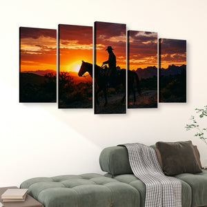 A five-panel canvas wall art set depicting a cowboy riding a horse at sunset, displayed above a green sofa in a living room setting.
