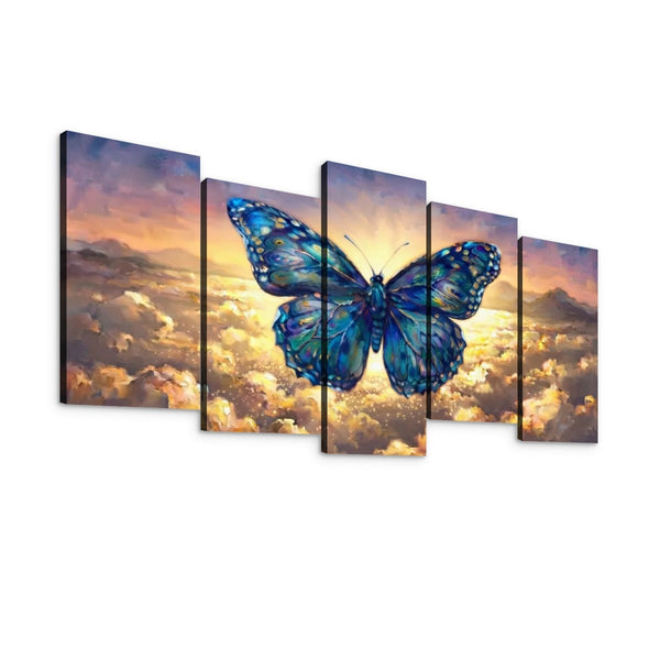 Five-panel canvas wall art showing a large blue butterfly over a dramatic sky with clouds and mountains at sunset, displayed against a plain white background.