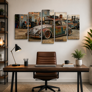 A 5-panel canvas wall art set depicting a vintage rusted blue VW Beetle car in a junkyard, displayed on a white wall above a wooden desk with a brown leather office chair.