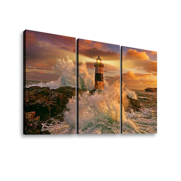 Three-panel canvas wall art showing a dramatic lighthouse scene with crashing waves and a warm sunset sky, displayed against a plain white background.