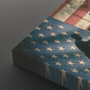A close-up of a rectangular canvas or print featuring a distressed American flag design with white stars on a blue field and red-and-white stripes, shown at an angle against a dark gray background.