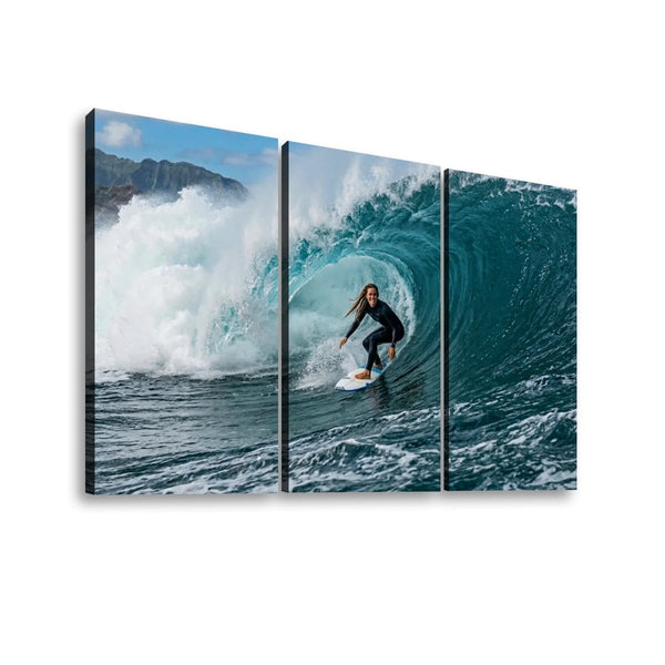 Three-panel canvas wall art showing a surfer riding inside a large curling ocean wave, displayed against a plain white background.