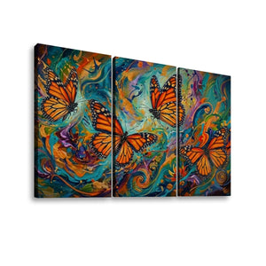 Three-panel canvas wall art showing three orange monarch butterflies over a vivid abstract background of swirling teal, blue, yellow, purple, and orange paint, displayed against a light gray wall.