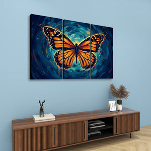A three-panel canvas wall art set featuring a large orange and black butterfly over a swirling blue and teal background, displayed above a wooden console table in a styled room with a light blue wall.
