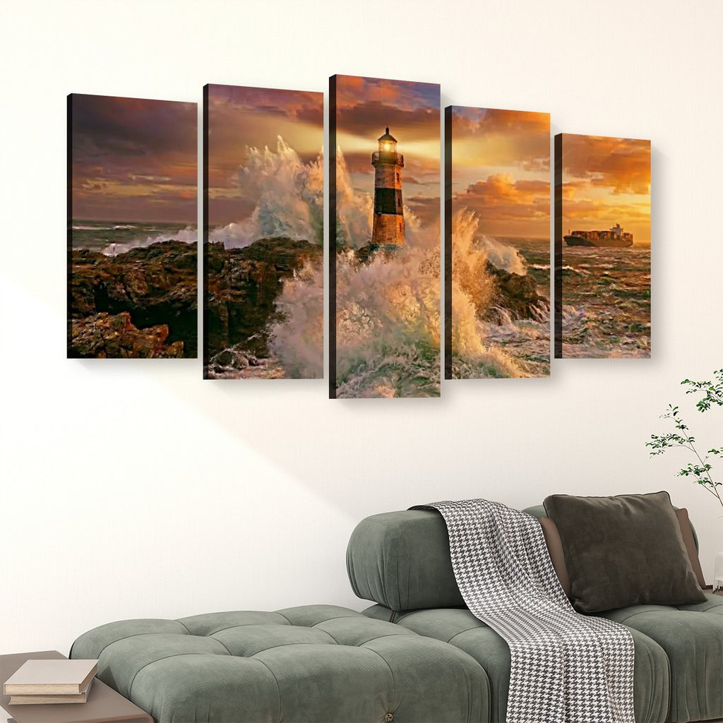 A five-panel canvas wall art set depicting a dramatic lighthouse scene with crashing waves at sunset, displayed above a green sofa in a living room setting.