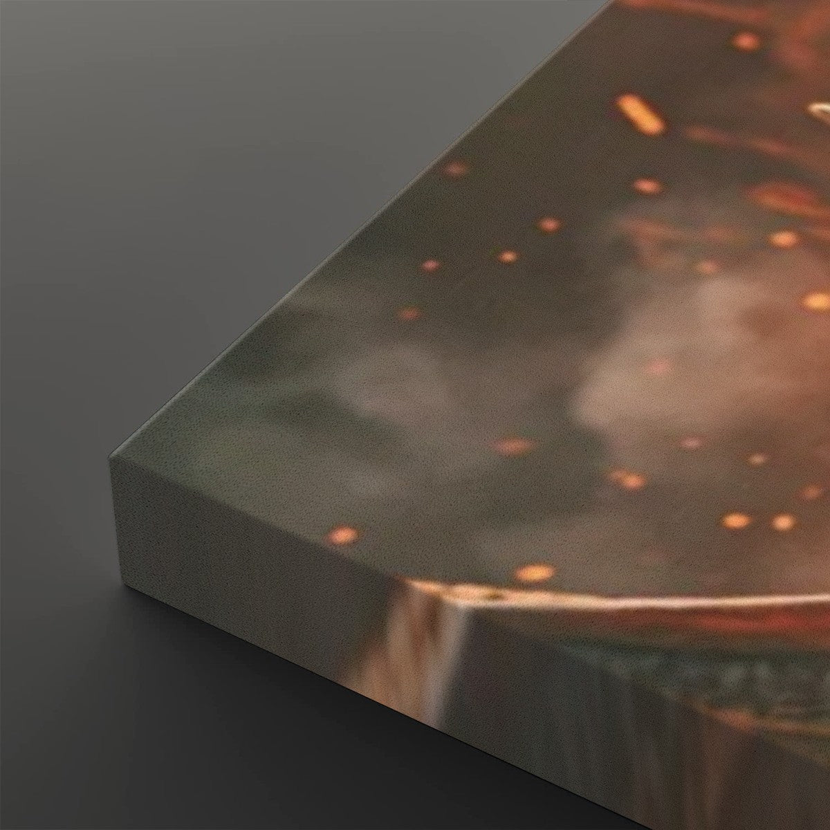 A close-up of a rectangular panel or tile with a printed abstract design in smoky gray, brown, and orange tones, with small glowing speckles and a reflective metallic-looking edge, shown on a dark gray background.