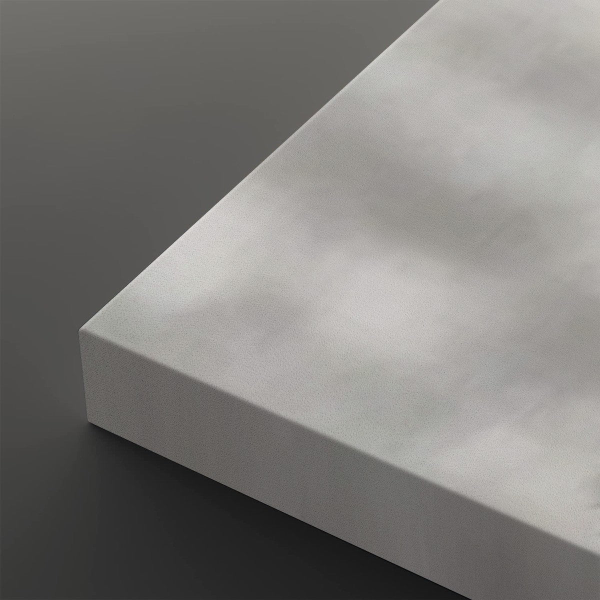 A close-up of a light gray rectangular panel or board shown at an angle against a dark gray background.