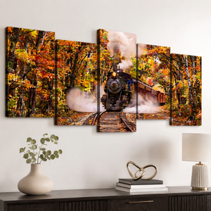 A five-panel canvas wall art set depicting a steam train traveling through an autumn forest with colorful orange, yellow, and brown foliage, displayed on a white wall above a dark wood console table with decorative items.