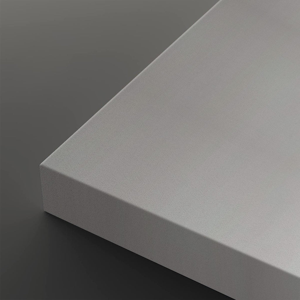 A close-up of a light gray rectangular panel or board corner, shown against a dark gray background.
