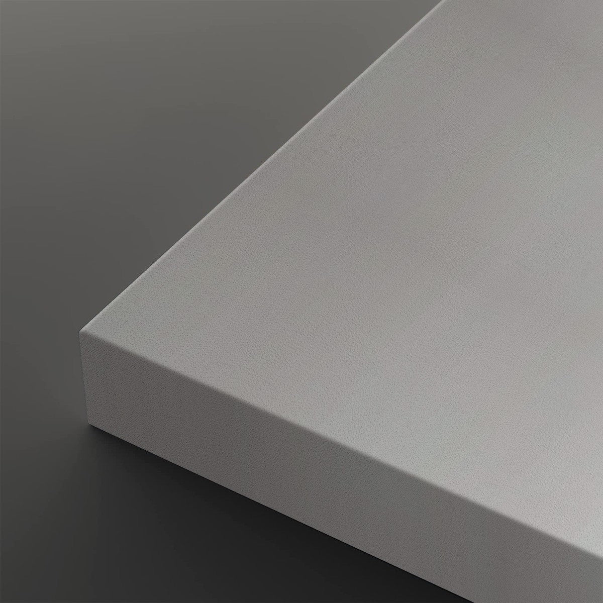 A close-up of a light gray rectangular panel or board corner, shown against a dark gray background.