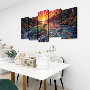 A 5-panel canvas wall art set depicting a colorful sunset seascape with a sea turtle, displayed on a white wall above a dining table in a modern room setting.