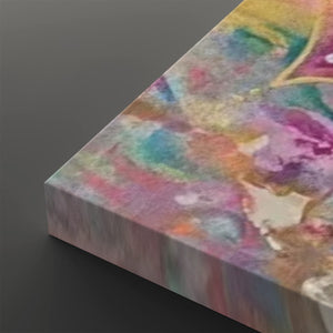 A close-up of a rectangular canvas or panel with an abstract multicolor painted surface, shown at an angle against a dark gray background.