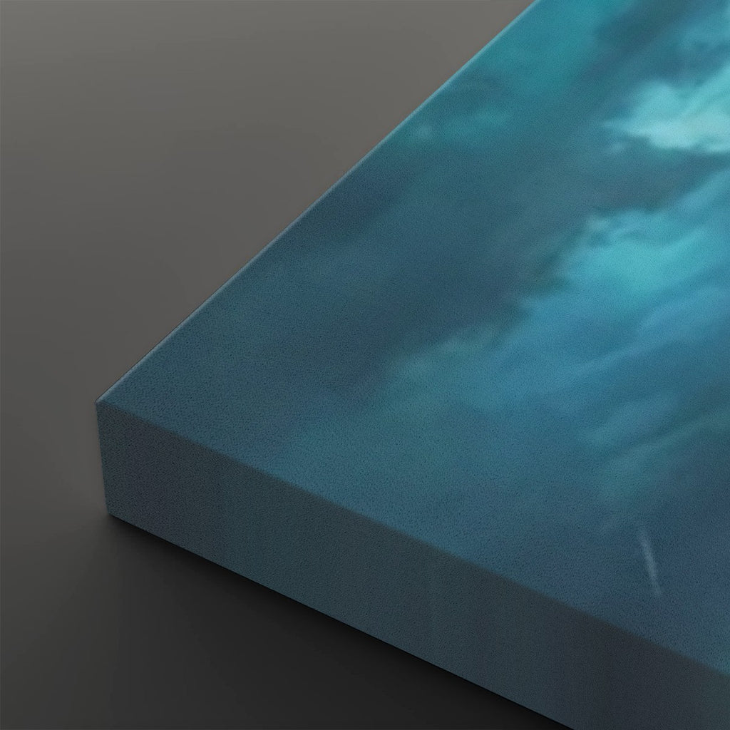 A close-up of a square canvas print showing its wrapped edge, featuring a textured blue and teal sky with soft white clouds on a dark gray background.