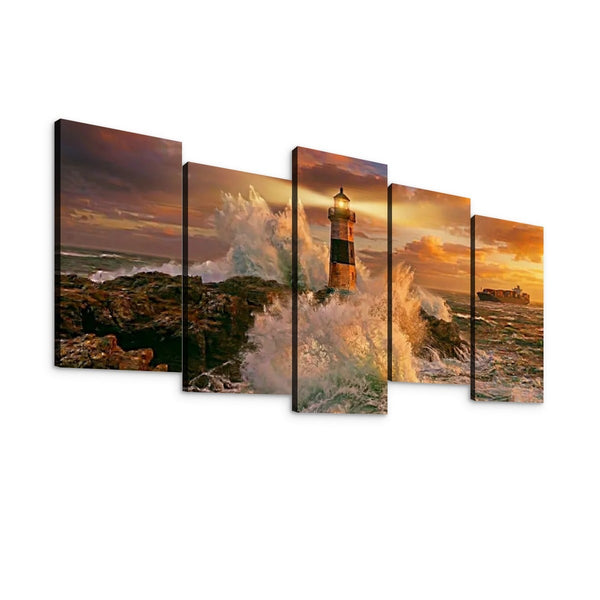 A five-panel canvas wall art set depicting a dramatic coastal lighthouse scene at sunset, with crashing waves, rocky shoreline, and warm golden sky, shown against a plain white background.