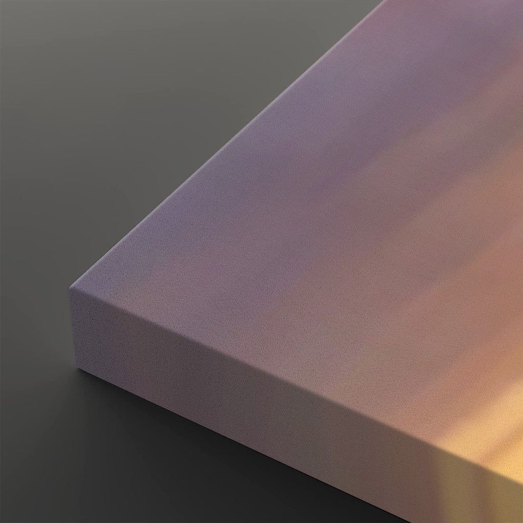 A close-up of a rectangular block with a smooth, matte iridescent surface showing a gradient of purple, pink, and warm gold tones under directional light, set against a dark gray background.