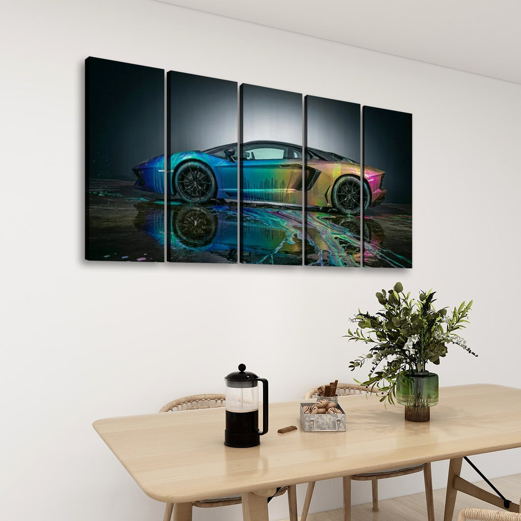 A five-panel canvas wall art set depicting a Lamborghini sports car with a vibrant rainbow reflection, displayed on a white wall above a wooden dining table with a vase of greenery and a French press.