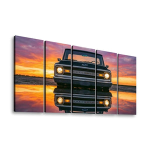 A five-panel canvas wall art print depicting a black 1970 Chevy C10 pickup truck at sunset with its reflection on water, shown against a plain white background.