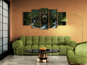 Green sofa in a living room with a large wall art piece depicting a bear in a forest.