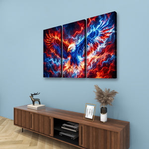 A three-panel canvas wall art set depicting a fiery phoenix with vivid red, orange, and blue flames, displayed on a light blue wall above a wooden console table with decorative items.