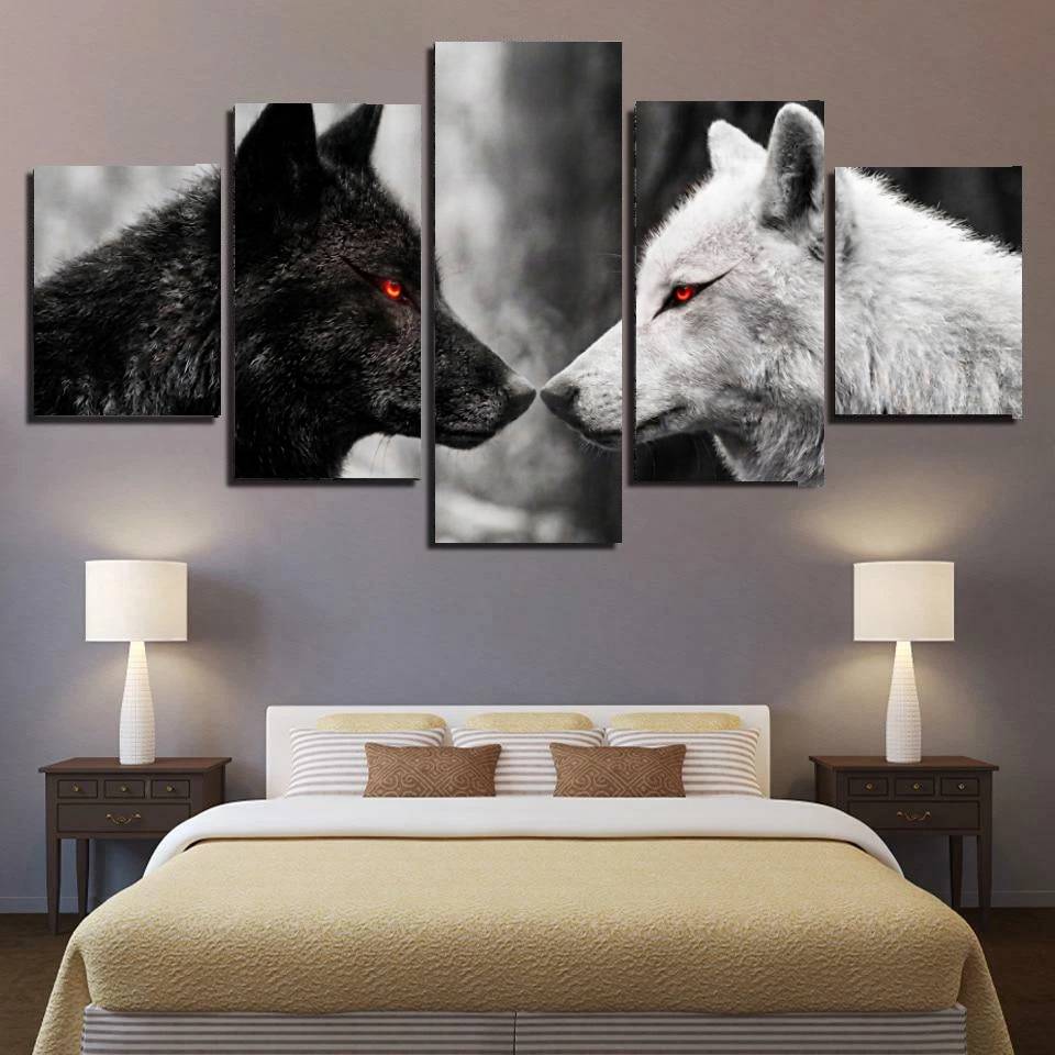 Five-panel wall art of black and white wolves with red eyes in a bedroom setting.