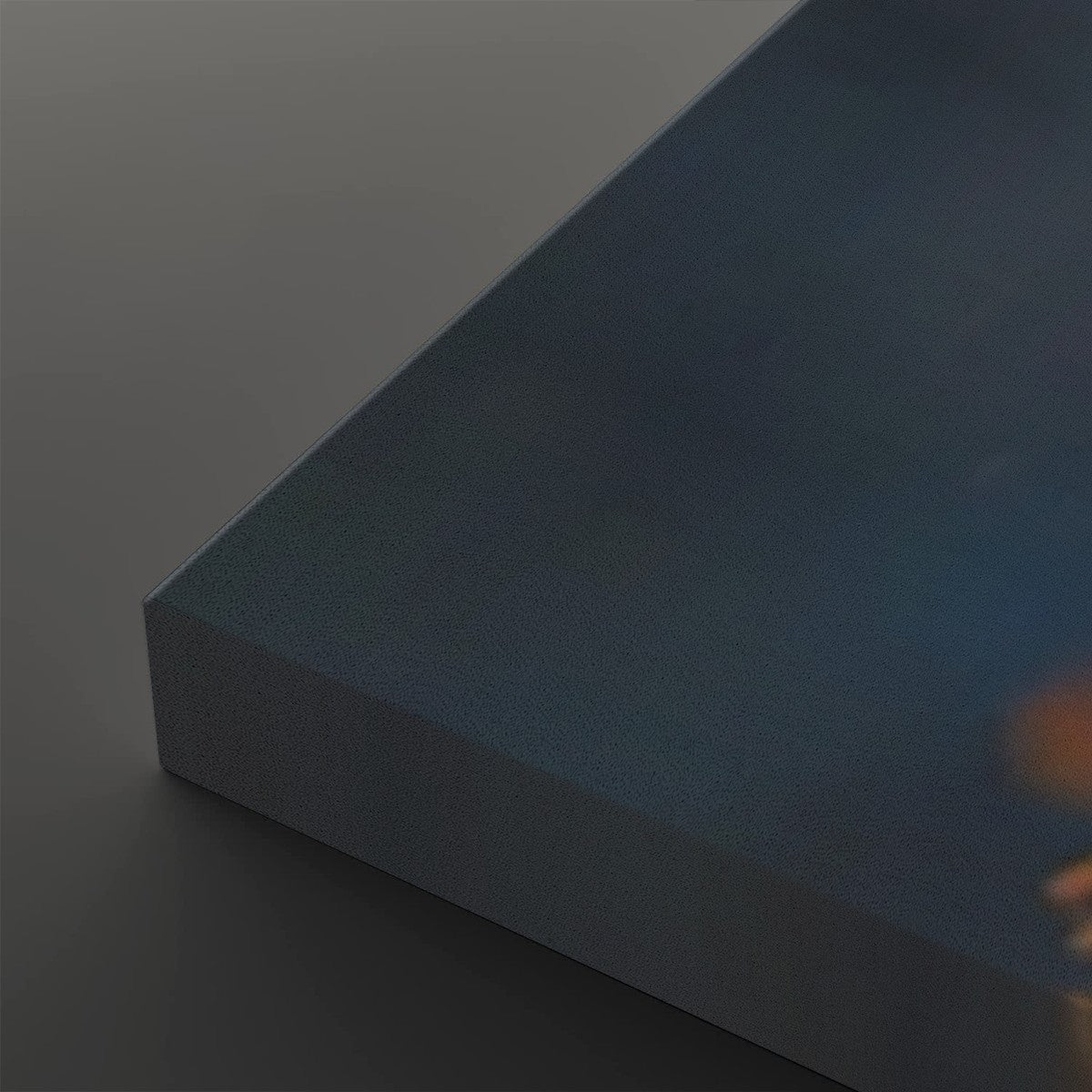 A close-up of a rectangular canvas or panel with a dark blue textured surface, shown at an angle against a dark gray background.