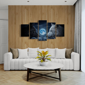 A 4-panel canvas wall art set depicting a wolf and a moon, displayed in a modern living room setting above a white sofa.