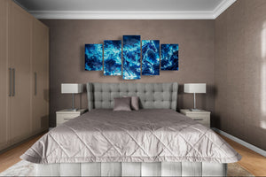 Bedroom with a large bed and abstract blue wall art