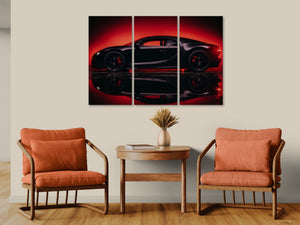 A three-panel canvas wall art print depicting a black Bugatti Chiron sports car in dramatic red lighting, displayed on a beige wall above a wooden side table with two orange armchairs.