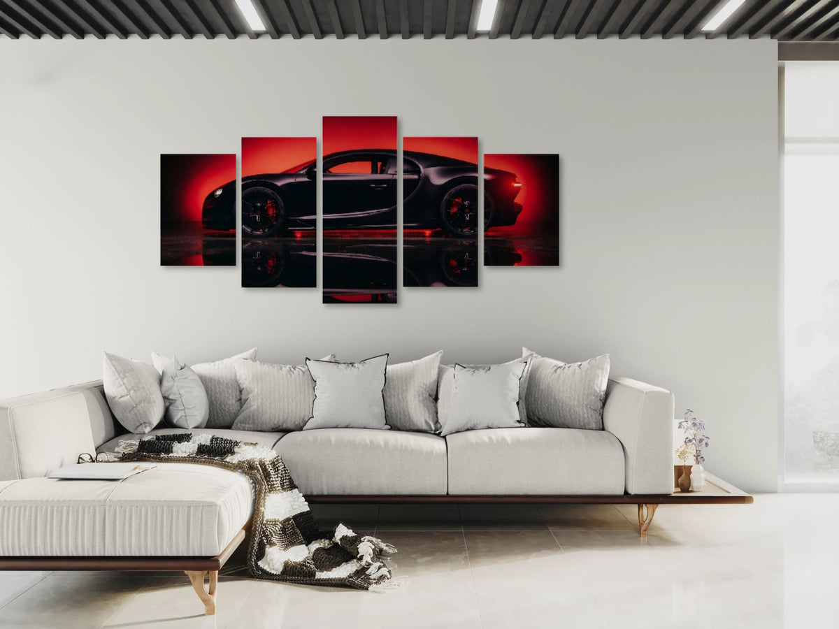 A 5-panel canvas wall art set depicting a sleek Bugatti Chiron sports car in dramatic red and black lighting, displayed on a white wall above a modern white sectional sofa in a contemporary living room.
