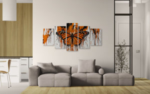 Gray sectional sofa in a living room with Monarch butterfly artwork on the wall.