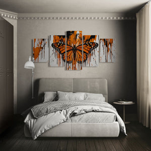 Bedroom with a large Monarch  butterfly painting on the wall above a bed.