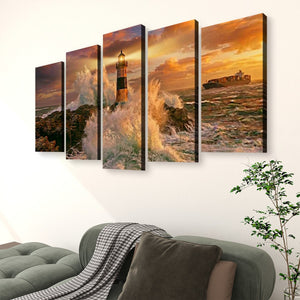 A five-panel canvas wall art set depicting a dramatic lighthouse and rocky shoreline at sunset, displayed above a green sofa in a living room setting.