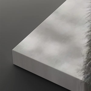 A close-up of a white rectangular canvas or panel with a soft gray shadow pattern across its surface, shown at an angle on a dark gray background.