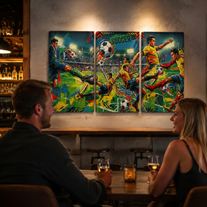 A three-panel canvas wall art set depicting a vibrant, colorful soccer match scene, displayed on a rustic wall above a bar table where a man and a woman are seated and looking at the artwork.