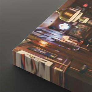 A rectangular wall art print or canvas shown at an angle on a dark gray background. The printed scene depicts a warmly lit interior with wooden furniture, books, and hanging lamps.