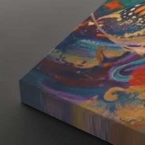 A close-up angled view of a colorful abstract canvas print showing vivid swirls of blue, purple, orange, yellow, and red on a dark gray background.
