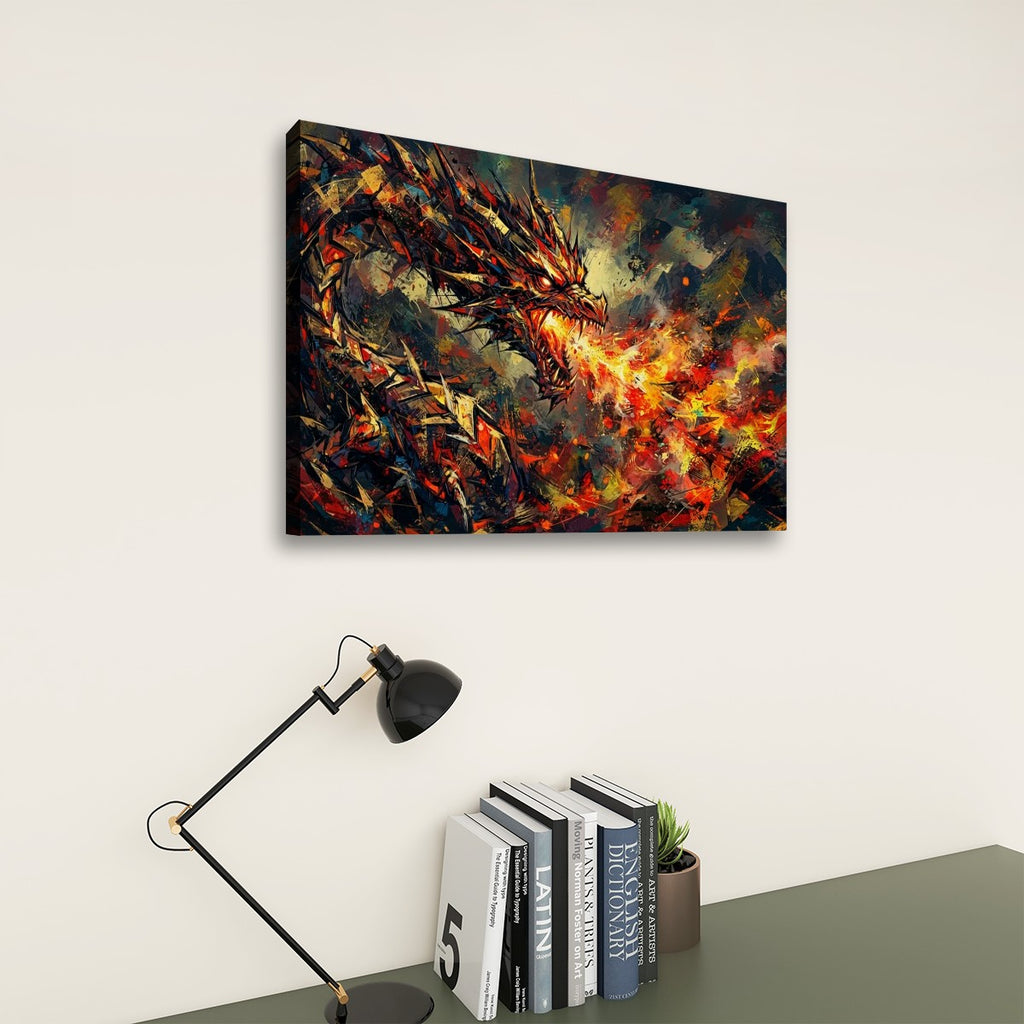A rectangular wall art print showing a dramatic fiery dragon in dark black, orange, red, and yellow tones, displayed above a desk with a black lamp and books against a light beige wall.