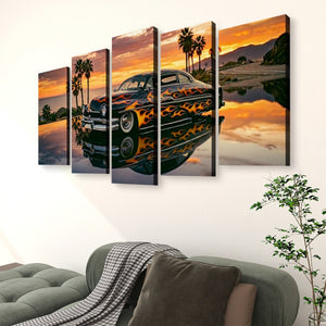 A five-panel canvas wall art set depicting a black Mercury Sled with orange and yellow flames, set against a sunset beach scene with palm trees and water reflection, displayed above a green sofa in a living room setting.
