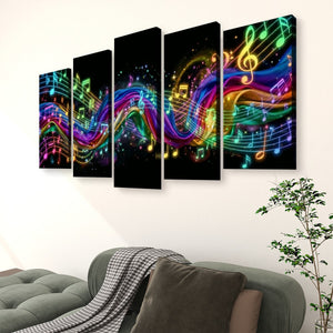 A 5-panel canvas wall art set depicting vibrant, colorful musical notes and flowing sound waves on a black background, displayed on a white wall above a green sofa in a living room setting.